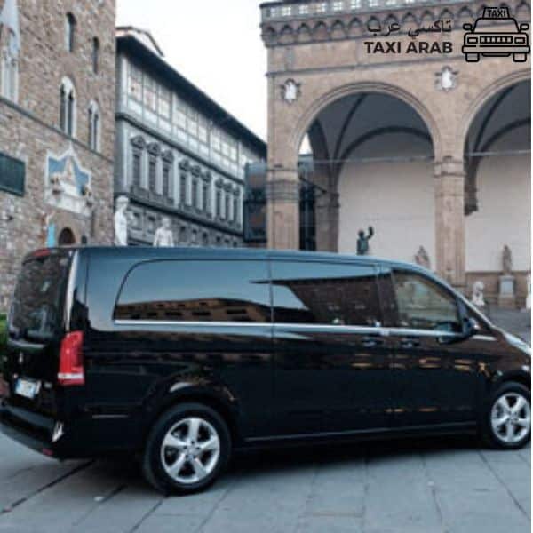 Black van in historic plaza